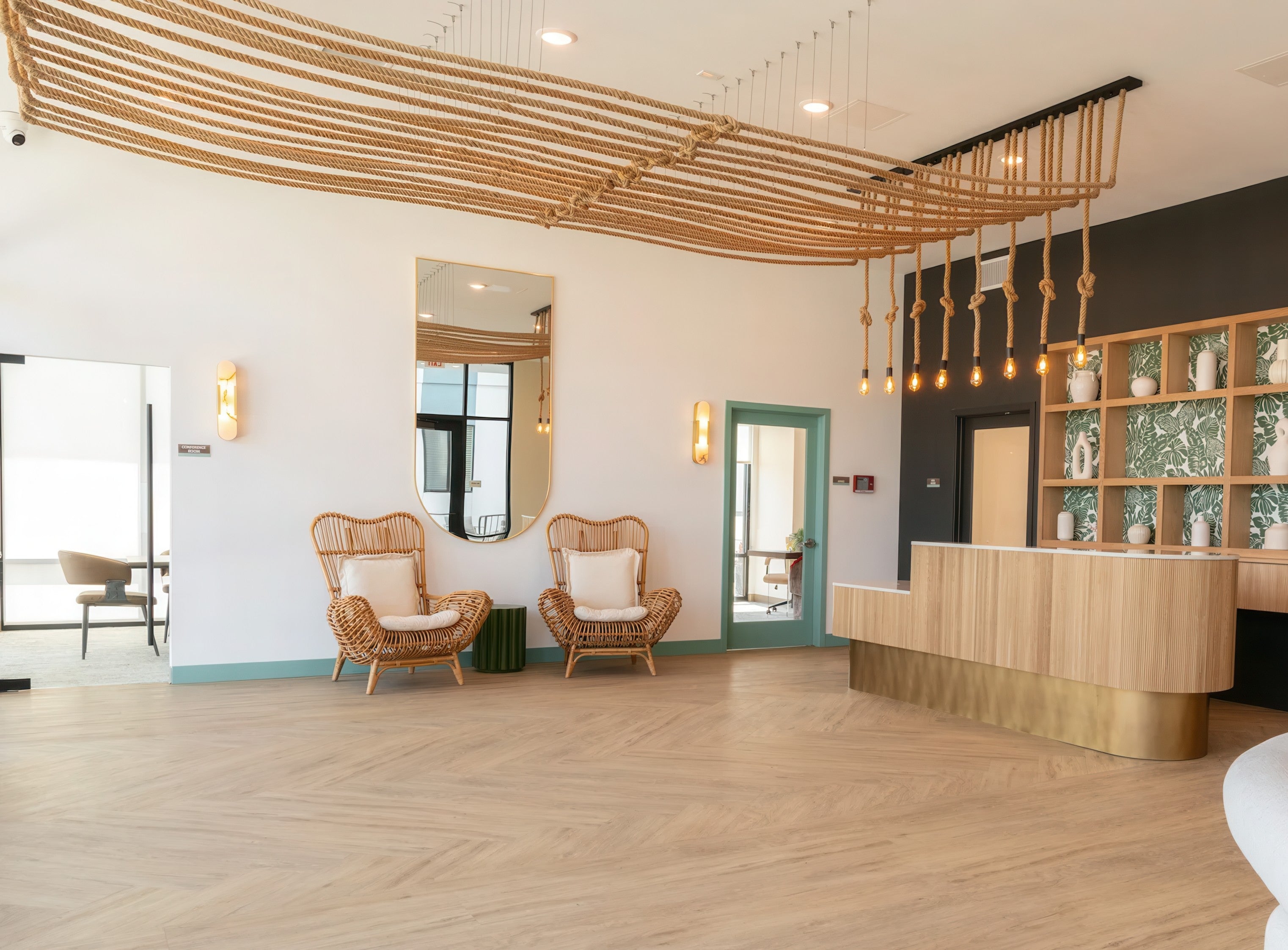 Modern interior design with wooden chairs, a reception desk, and decorative elements. Large custom rope pendant light installation ceiling suspension