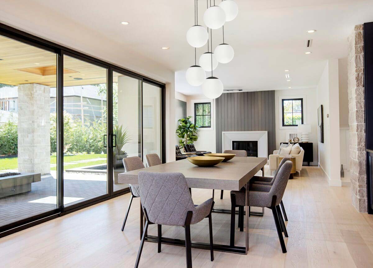 modern open dining room with pendant light chandelier large white globes