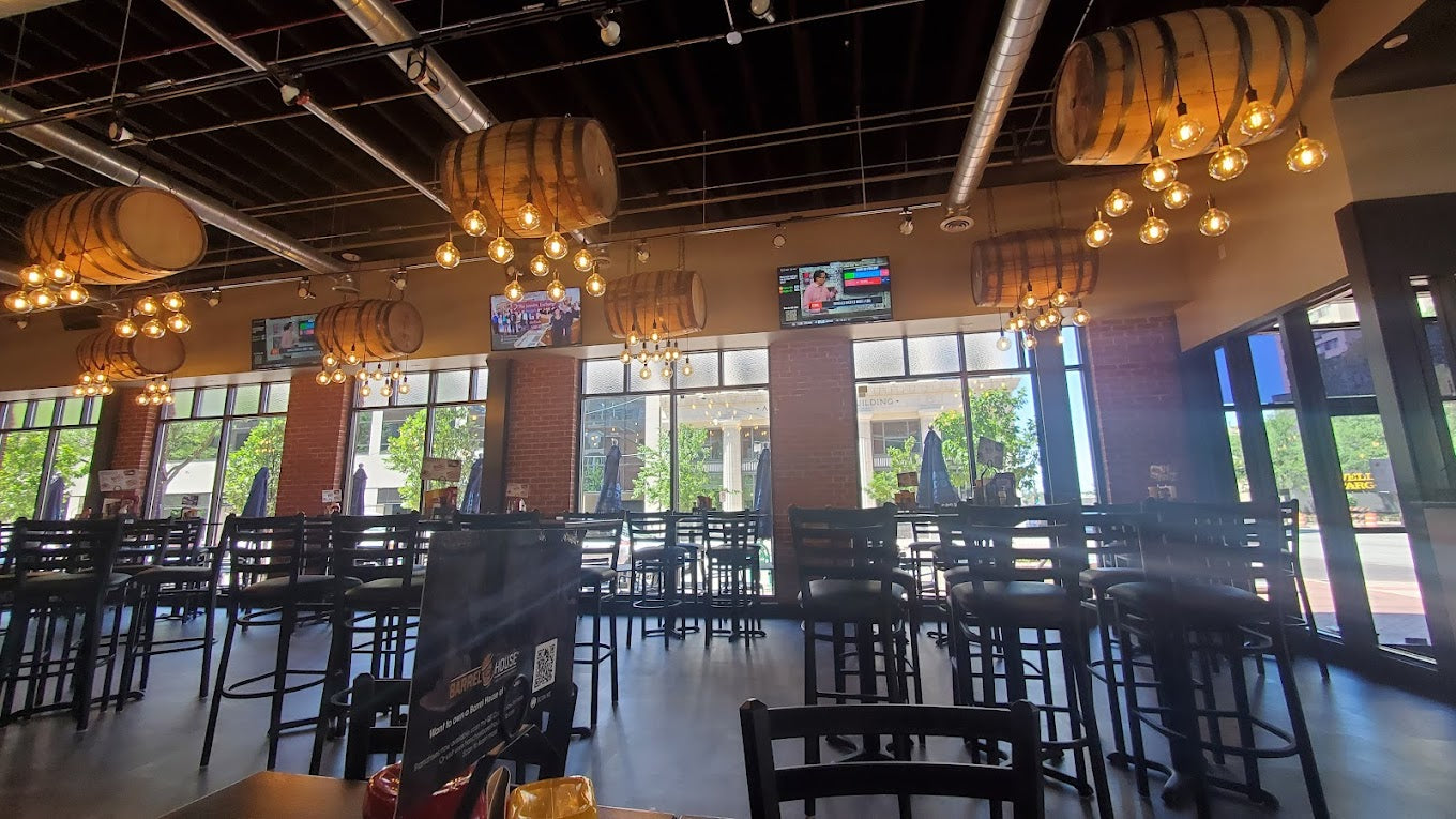 restaurant with wooden barrel-shaped lights hanging from the ceiling.