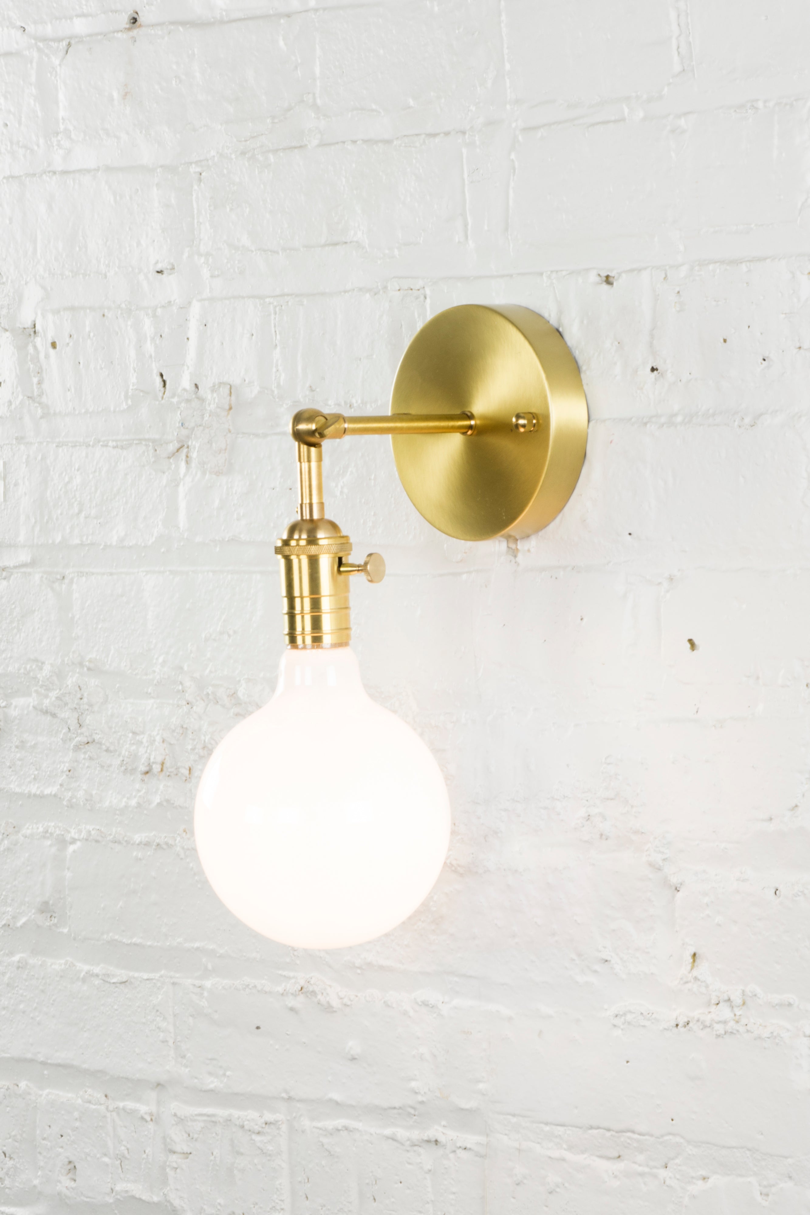 Hinge Arm Wall Sconce: Brass with White 5" Globe
