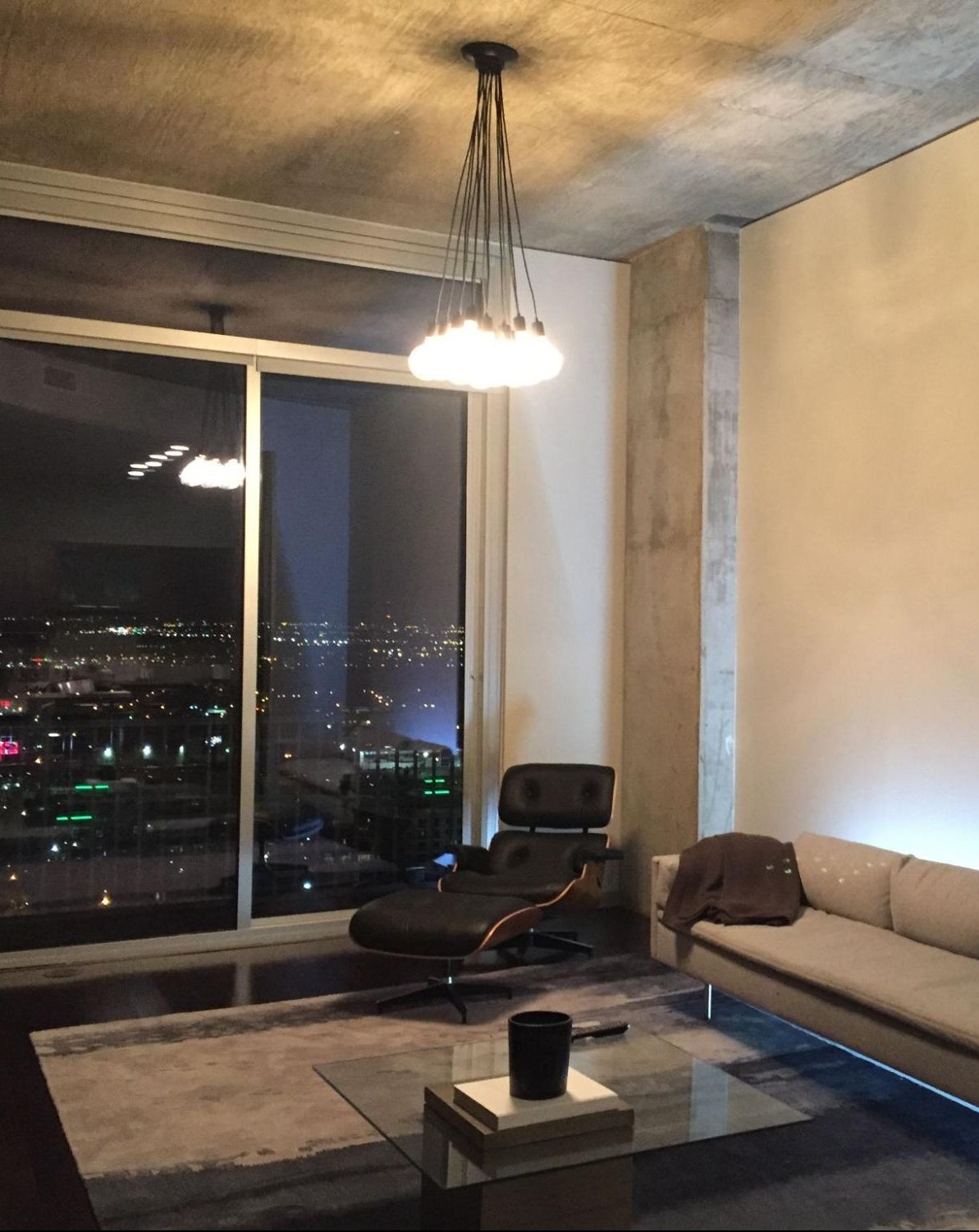 Modern living room with a cityscape view at night