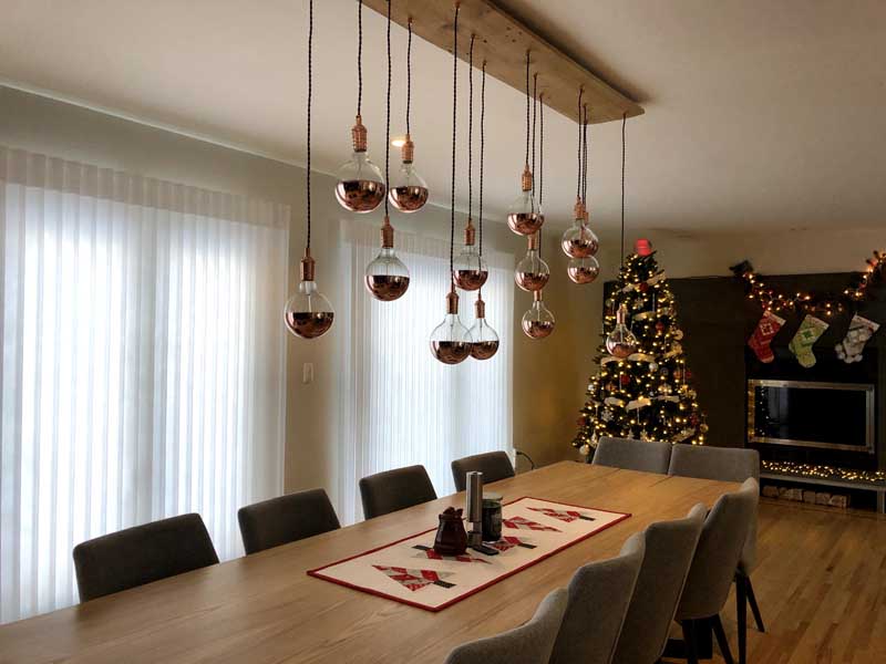 natural wood chandelier with multiple pendant lights and copper dipped bulbs