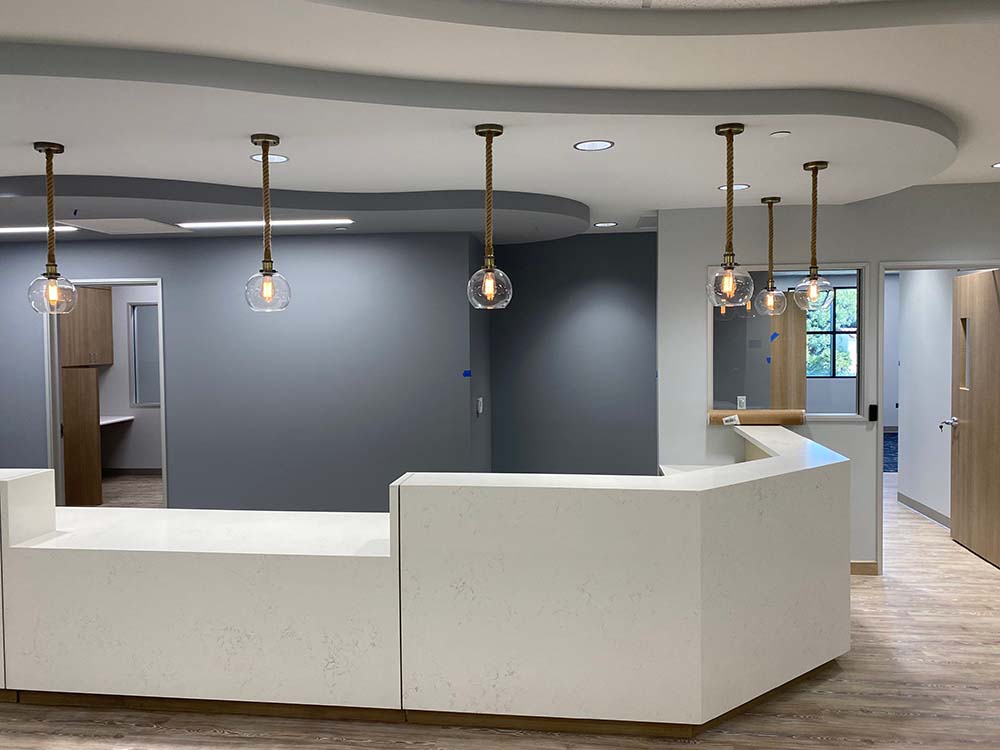 rustic rope pendant lights over reception area with glass globe shades