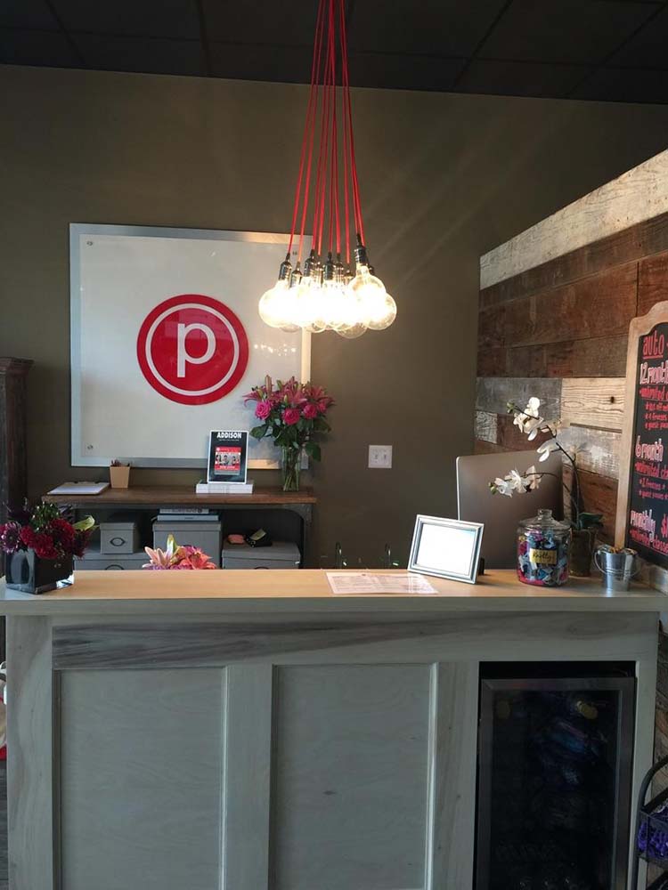 Red pendant light cluster over reception desk