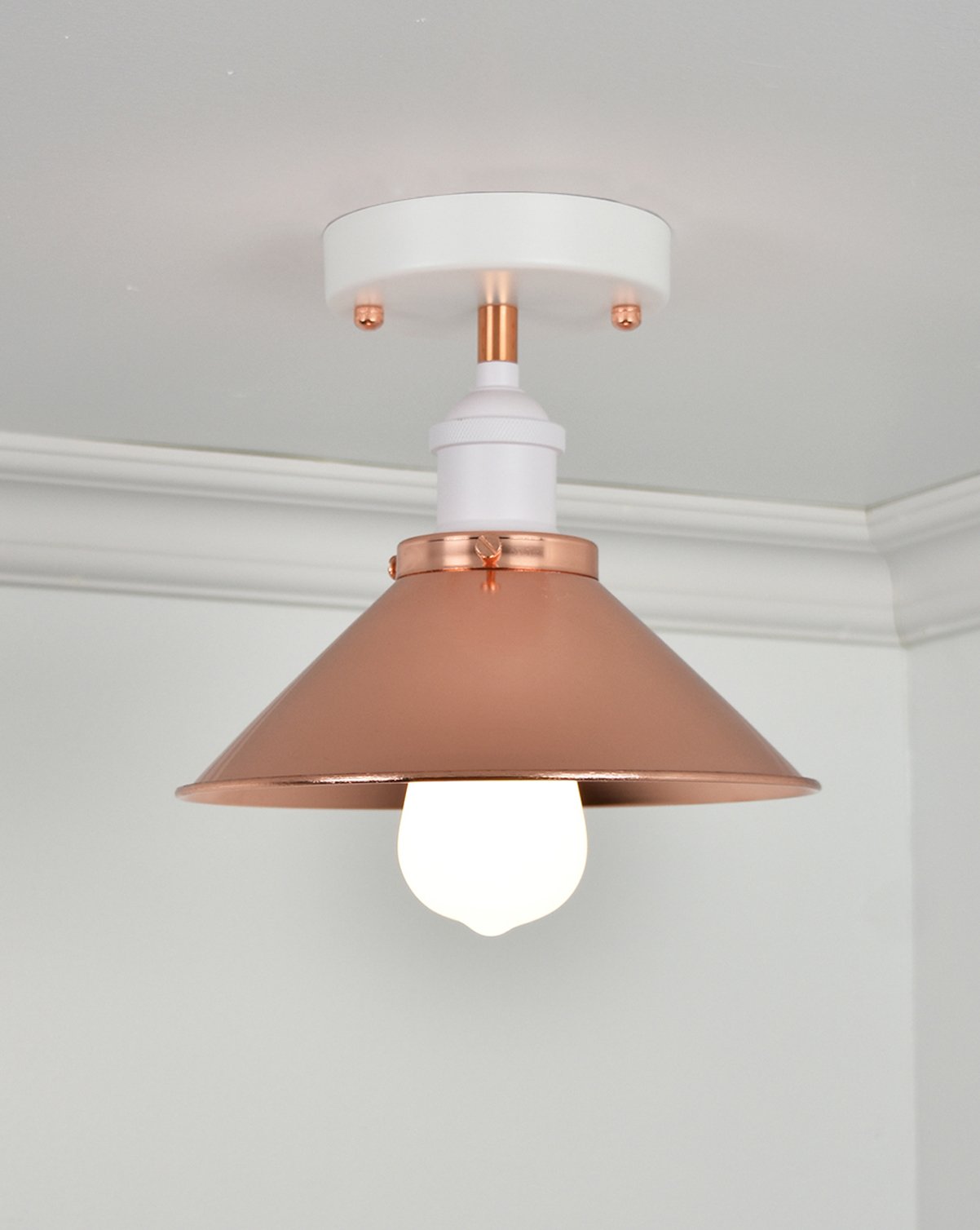 Semi-flush mount light fixture with a white base, copper metal shade, and an exposed bulb.