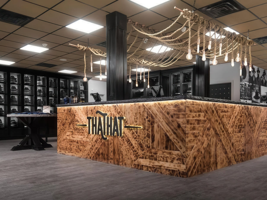 unique retail lighting counter with reclaimed wood and rope pendants