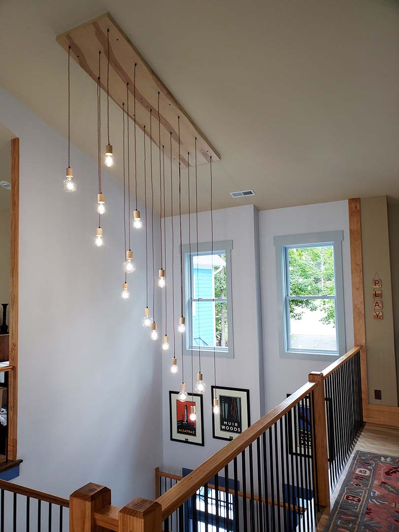 Cascading Wood Pendant Light Chandelier in Stairway